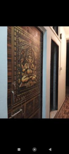 a wooden door with a painting on it at Sada Shiv Guest House in Varanasi