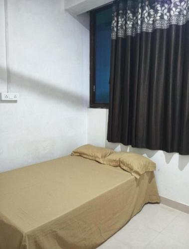 a bed in a room with a black curtain at Sada Shiv Guest House in Varanasi