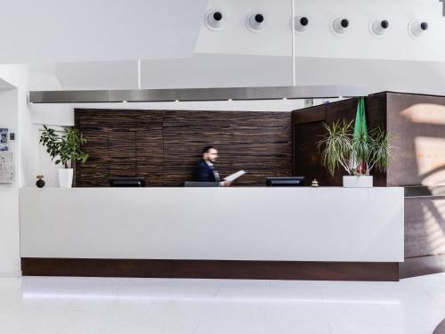 a man sitting at a desk in an office at Ibis Styles Milano Centro in Milan