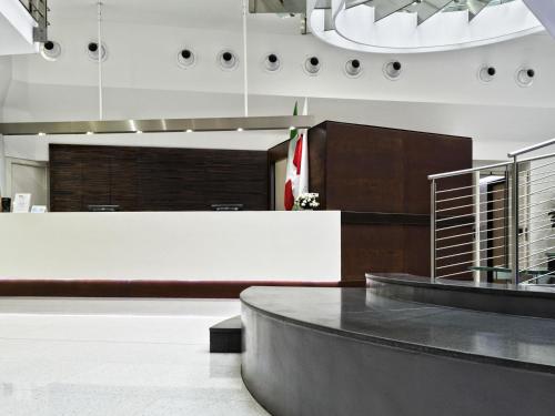 a lobby with a reception desk in a building at Ibis Styles Milano Centro in Milan