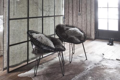 two chairs covered in fur sitting in a room at Siggesta Gård in Värmdö