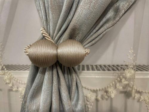 a curtain with two balls on top of it at Tiny Mara in Râmnicu Vâlcea