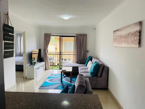a living room with a couch and a table at Basiliea Mews in Durban