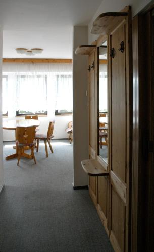 a room with a table and a dining room at Penzion Bobešova bouda in Železná Ruda
