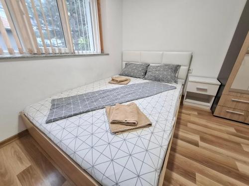 a small bedroom with a bed with a white mattress at Ruse Charm Studio 3 in Ruse