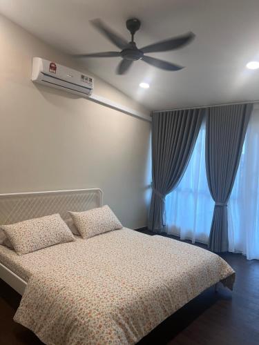 a bedroom with a bed with a ceiling fan and a window at Rumah Lea, Hafsah & Luqman in Seremban