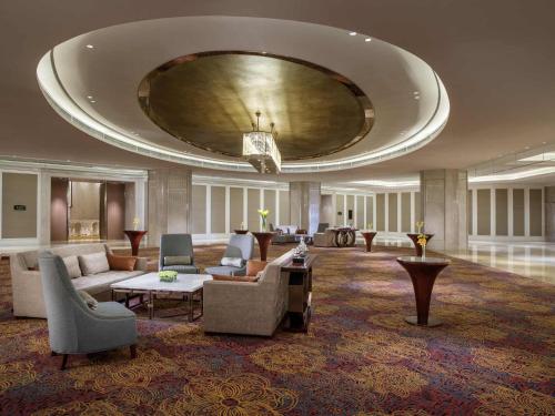 a lobby with a large room with couches and tables at The Sebel Xining-Managed By Sofitel in Xining