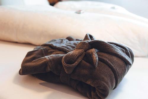 a towel is sitting on top of a bed at Burgstadl Aparthotel & Restaurant in Ladis
