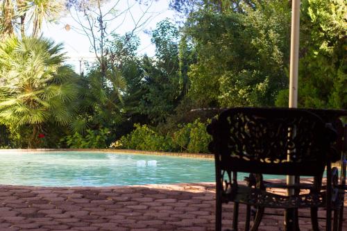a chair sitting in front of a swimming pool at Riverside Lodge & Conference Center in Aliwal North