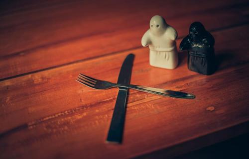 a fork and knife sitting on top of a wooden table at Ela Ecoland Nature Retreat in Munnar