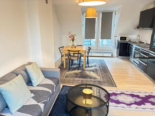 a living room with a couch and a table at Metro Apartment Linde Alle 14, 3Th 2720 Vanløse in Copenhagen