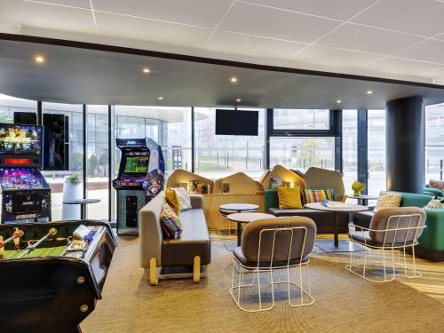 a gaming room with a bunch of games at ibis Styles Paris Charles de Gaulle Airport in Roissy-en-France