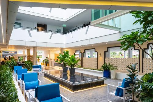 a lobby with blue chairs and a fountain at Chalong Marina Bay View Rawai Phuket in Rawai Beach