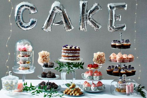 a table with desserts and a cake and a word cure at Delta Hotels by Marriott Edinburgh in Edinburgh