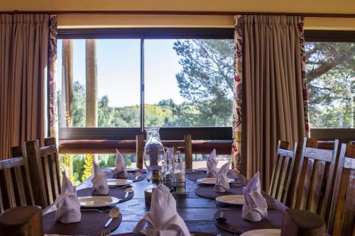 a dining room with a table with a large window at Riverside Lodge & Conference Center in Aliwal North