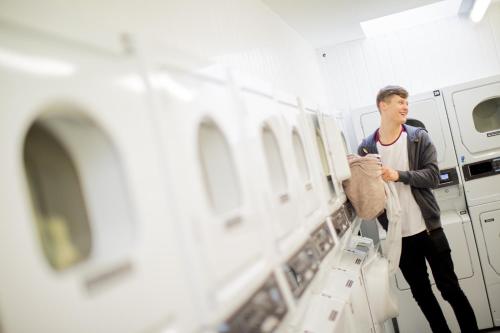 a man in a laundry room looking at machines at University of Essex - Colchester Campus in Colchester