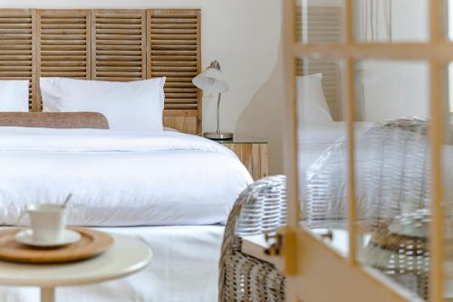 a bedroom with two beds and a table with a cup of coffee at Cap de Castel in Puylaurens