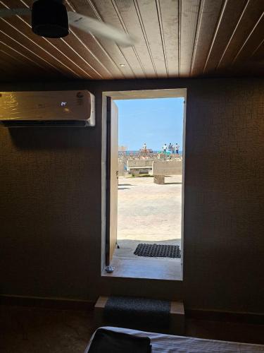 a room with an open door with a view at The Sangam Narayan in Dwarka