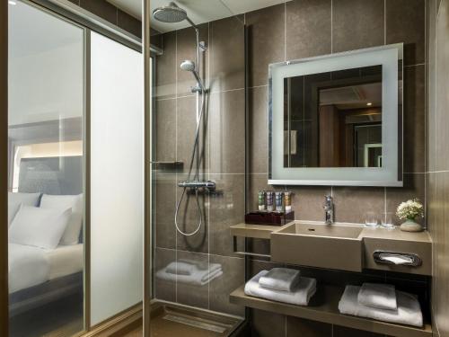a bathroom with a shower and a sink at Novotel Istanbul Bosphorus Hotel in Istanbul