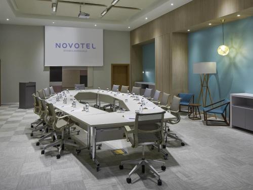 a conference room with a large table and chairs at Novotel Istanbul Bosphorus Hotel in Istanbul