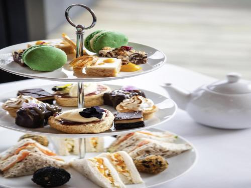 two plates with different types of pastries on them at Novotel New Plymouth Taranaki in New Plymouth