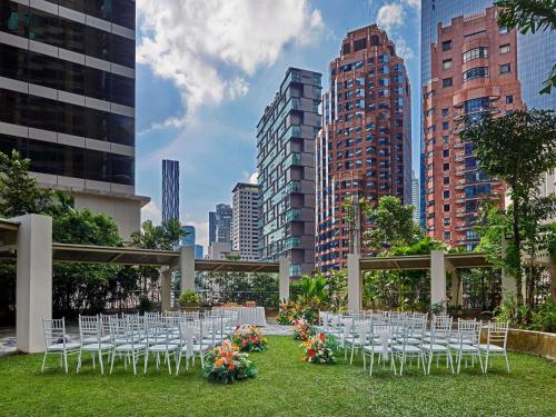 a bunch of chairs are set up for a wedding in a city at Pullman Kuala Lumpur City Centre Hotel & Residences in Kuala Lumpur