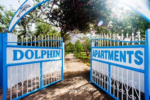 a pair of blue gates with the words dophinning at Dolphin Apartments in Frangokastello