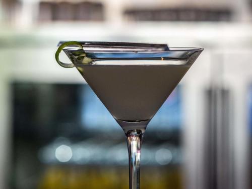 a martini glass with a lime in it at Mercure Hyderabad KCP Banjara Hills, An Accor Hotel in Hyderabad