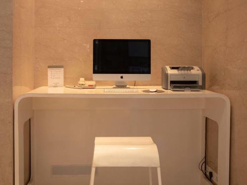 a desk with a computer and a printer on it at Mercure Hyderabad KCP Banjara Hills, An Accor Hotel in Hyderabad