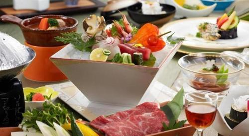 a table with a plate of food on it at Shiratamano Yu Kahou in Shibata