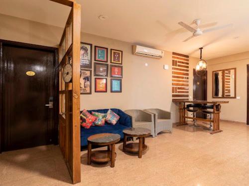 a living room with a blue couch and a table at Hotel Imperial Park in Gurgaon