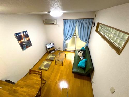 a living room with a couch and a table at About a 3minute walk from JR Nishi-Ogikubo St, in Kichijōji