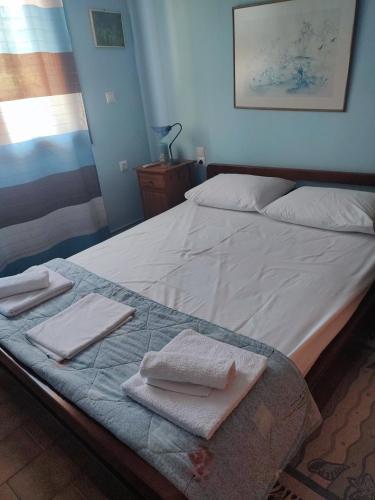 a large bed with towels on it in a room at Villa Koliri in Pýrgos