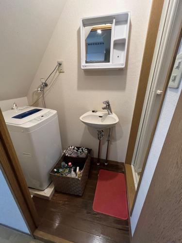 a small bathroom with a sink and a toilet at About a 3minute walk from JR Nishi-Ogikubo St, in Kichijōji