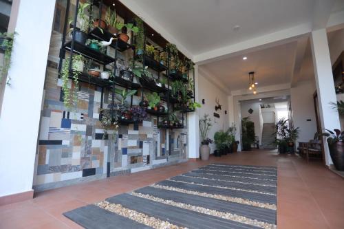 a hallway with potted plants on the wall at Hotel Magdalina Lagoon in Negombo