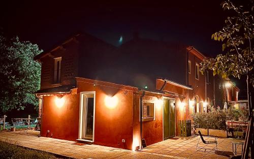 a house with lights on the side of it at night at Camera tripla Il Picchio Verde in Altopascio