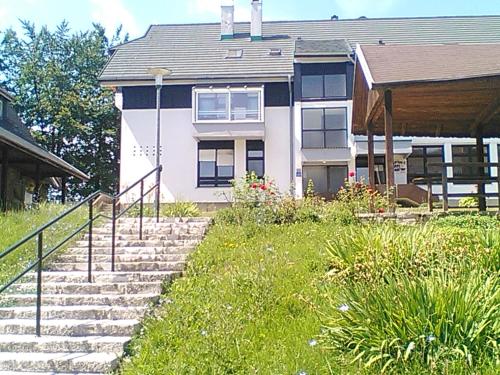 a house with stairs in front of it at Art Apartman in Plitvička Jezera