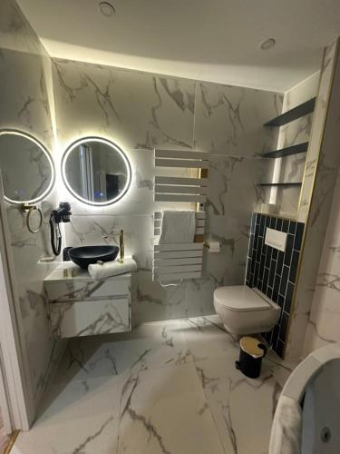 a white bathroom with a sink and a toilet at MOON - 44 in Nice