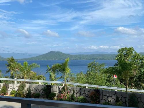 a view of a body of water from a balcony at Overlooking Taal Lake and Nature Vibe Staycation in Kinalaglagan