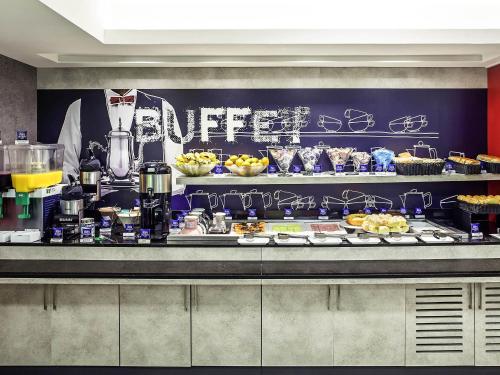 a buffet line with food and drinks in a restaurant at ibis budget RJ Copacabana in Rio de Janeiro