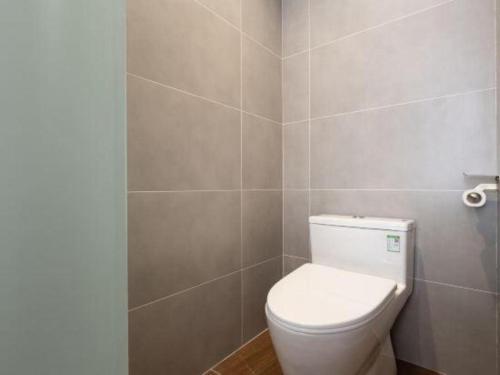 a bathroom with a white toilet in a room at James Joyce Coffetel·Lijiang Old Town Centeral in Lijiang