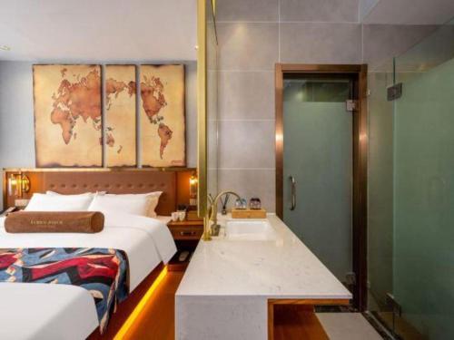 a bedroom with a bed and a bathroom with a sink at James Joyce Coffetel·Lijiang Old Town Centeral in Lijiang
