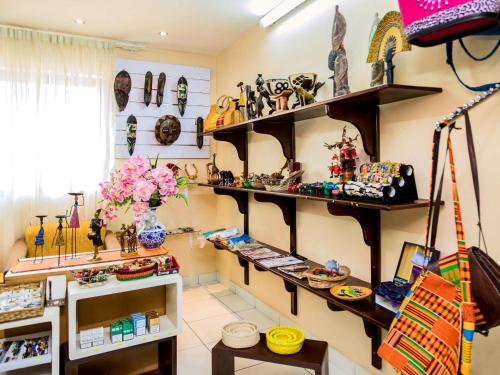 a room with shelves of vases and other items at Ibis Styles Accra Airport in Accra