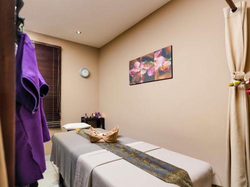 a hospital room with two beds and a window at Ibis Styles Accra Airport in Accra