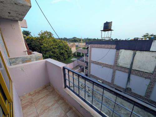 a balcony of a building with a water tower at Oslo Gardens Airport in Entebbe