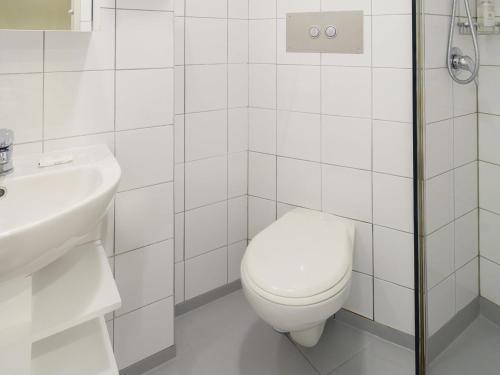 a white bathroom with a toilet and a sink at Ibis Styles Invercargill in Invercargill