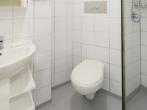 a white bathroom with a toilet and a sink at Ibis Styles Invercargill in Invercargill