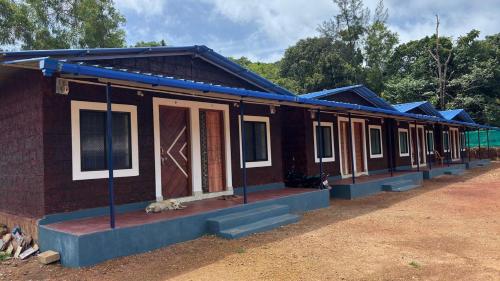 a row of houses on a dirt road at Green home stay in Ankola