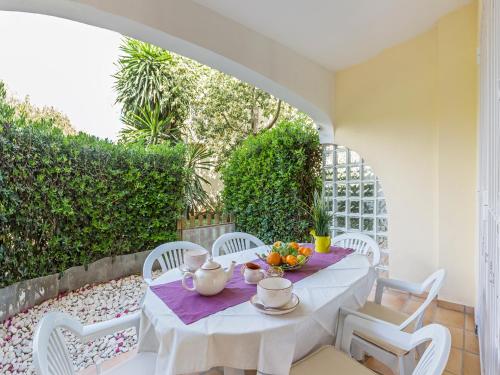 a white table and chairs on a patio at Apartamento Esmeralda VyB in Denia