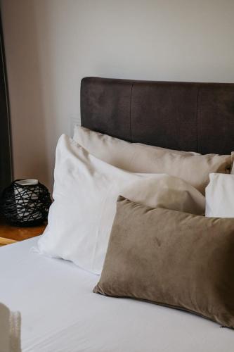a pile of pillows sitting on top of a bed at Welcome Douro - Eco Camping Resort in Cinfães
